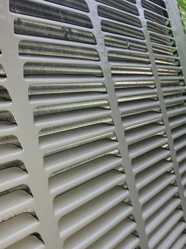 Responded to service call for non-operational air conditioning unit with reported fan and compressor failure. Upon arrival, performed visual inspection of outdoor condensing unit and verified electrical power supply at disconnect. Documented equipment condition with photographs showing exterior cabinet panels and condenser coil assembly for service records.