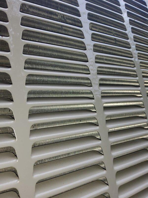 Responded to service call for non-operational air conditioning unit with reported fan and compressor failure. Upon arrival, performed visual inspection of outdoor condensing unit and verified electrical power supply at disconnect. Documented equipment condition with photographs showing exterior cabinet panels and condenser coil assembly for service records.