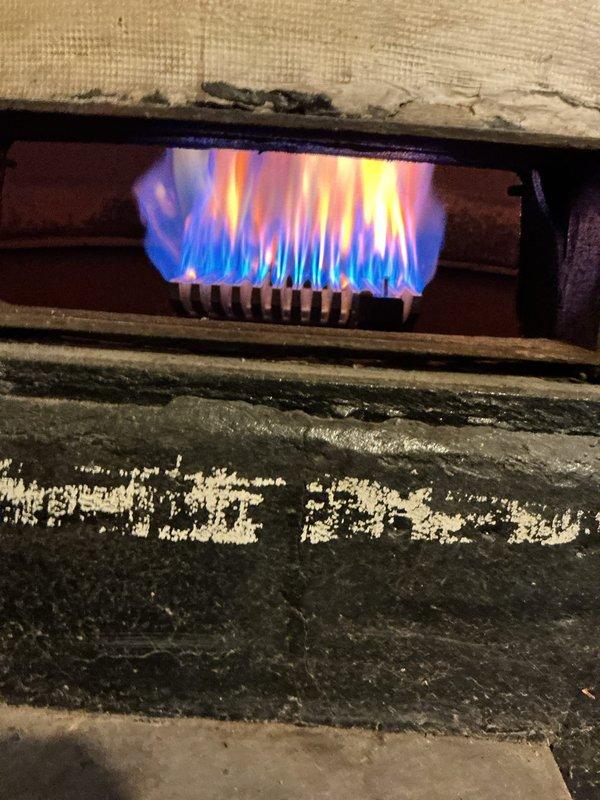 Completed comprehensive boiler tune-up and maintenance inspection on gas-fired heating system. Performed combustion analysis using diagnostic meter, verified proper burner operation with acceptable flame characteristics showing appropriate blue flame pattern, and inspected all accessible system components including gas piping, burner assembly, and heat exchanger surfaces for safe operation.