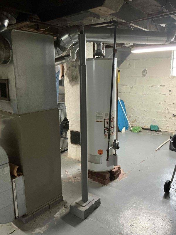 Conducted on-site evaluation of existing HVAC system in residential basement mechanical room for furnace replacement estimate. Assessed current beige/tan furnace unit and surrounding infrastructure, including ductwork configuration, water heater proximity, clearance requirements, and electrical connections. Documented equipment specifications, measured available space for new unit installation, photographed existing system layout and mechanical room conditions to prepare comprehensive replacement proposal.