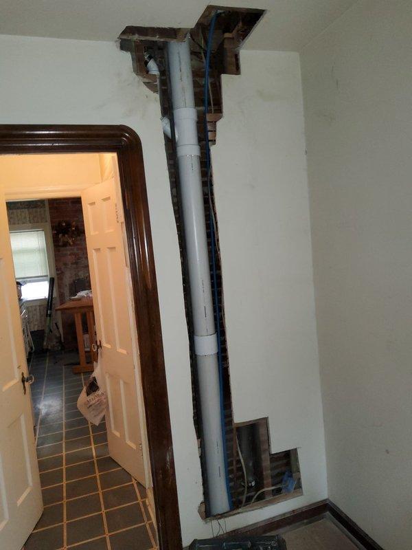Replaced deteriorated plumbing stack and toilet bends serving first and second floor bathrooms over a two-day period with two technicians. Installed new white PVC drain piping vertically through wall cavities, tying into existing branch drains for the second floor bathroom and connecting to existing cast iron stack for the third floor. Removed old plumbing infrastructure and opened walls as necessary to access and replace compromised drainage system. Installed two new customer-supplied toilets with proper connections to the new drain lines. Completed under-sink plumbing connections including chrome P-trap assembly, water supply lines, and shut-off valves. All drainage and supply connections tested and verified operational upon completion.