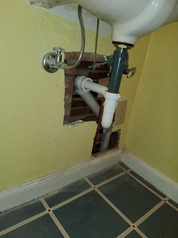Replaced deteriorated plumbing stack and toilet bends serving first and second floor bathrooms over a two-day period with two technicians. Installed new white PVC drain piping vertically through wall cavities, tying into existing branch drains for the second floor bathroom and connecting to existing cast iron stack for the third floor. Removed old plumbing infrastructure and opened walls as necessary to access and replace compromised drainage system. Installed two new customer-supplied toilets with proper connections to the new drain lines. Completed under-sink plumbing connections including chrome P-trap assembly, water supply lines, and shut-off valves. All drainage and supply connections tested and verified operational upon completion.
