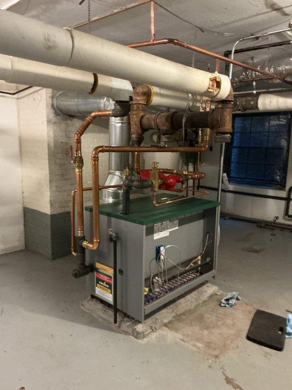 Performed annual maintenance on a 2-year-old residential boiler system. Conducted combustion analysis using digital analyzer, recording oxygen levels at 6.7%, CO at 3 ppm, CO2 at 8.1%, and stack temperature at 368.8°F, all within acceptable parameters. Inspected all mechanical components, copper piping connections, brass valves, and control systems in basement mechanical room. Customer inquired about system flushing service; advised that additional evaluation and separate quote would be required for that procedure.