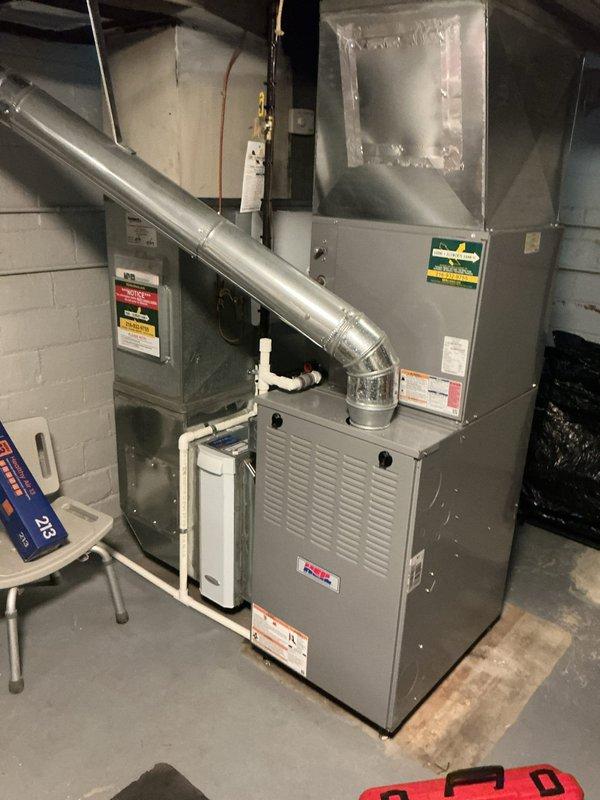 Completed routine furnace maintenance on 10-year-old residential heating system located in basement. Performed comprehensive inspection of furnace unit and associated HVAC components, verified proper operation of Emerson digital thermostat displaying current temperature settings, and ensured all safety labels and specifications were visible and intact. System tested and confirmed operational with all components functioning within normal parameters.