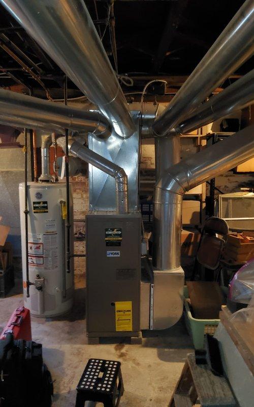 Completed comprehensive tune-up on 18-year-old residential gas furnace. Performed full system inspection including burner assembly examination, gas valve operation verification, and combustion analysis. Burners igniting properly with clean blue flame pattern across all ports, indicating proper air-to-fuel ratio. Inspected heat exchanger for cracks or deterioration, checked all electrical connections and wiring, verified proper venting and ductwork connections, and tested safety controls for proper operation. System operating within manufacturer specifications at time of service completion.