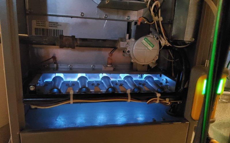 Completed comprehensive tune-up on 18-year-old residential gas furnace. Performed full system inspection including burner assembly examination, gas valve operation verification, and combustion analysis. Burners igniting properly with clean blue flame pattern across all ports, indicating proper air-to-fuel ratio. Inspected heat exchanger for cracks or deterioration, checked all electrical connections and wiring, verified proper venting and ductwork connections, and tested safety controls for proper operation. System operating within manufacturer specifications at time of service completion.