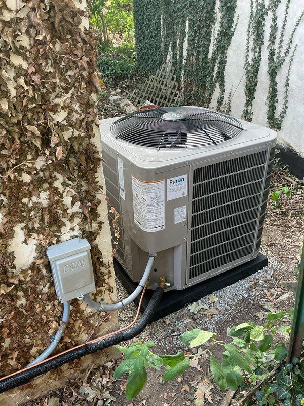 Completed final cleanup and startup procedures for newly installed HVAC system, including outdoor R-410A condenser unit with proper electrical disconnect and attic-mounted flexible ductwork installation. System was energized, tested for proper operation, and verified to be running within manufacturer specifications.