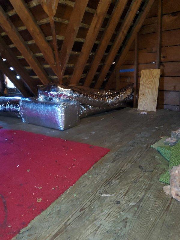 Completed final cleanup and startup procedures for newly installed HVAC system, including outdoor R-410A condenser unit with proper electrical disconnect and attic-mounted flexible ductwork installation. System was energized, tested for proper operation, and verified to be running within manufacturer specifications.