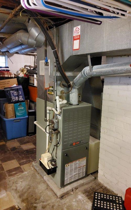 Performed comprehensive heating maintenance on an 11-year-old gas furnace located in basement. Conducted complete system inspection including combustion analysis using digital analyzer, which measured oxygen levels at 9.7%, carbon monoxide at 4 ppm, carbon dioxide at 6.4%, and flue temperature at 350.2°F. All combustion readings fell within acceptable parameters for safe and efficient operation. Inspected all ductwork connections, including metallic supply ducts and flexible insulated returns, confirming proper sealing and airflow distribution. Verified furnace components, burner assembly, heat exchanger, and blower motor operation. System tested and confirmed operational for heating season.