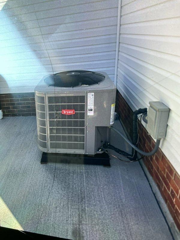 Completed compressor reinstallation on 2-year-old Bryant AC system. Installed new vibration isolation pad beneath outdoor condensing unit to ensure proper mounting and minimize operational vibration transfer. Unit repositioned on rooftop installation with electrical disconnect verified and refrigerant lines secured. System tested and returned to normal operation.