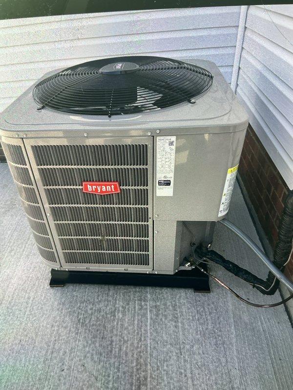 Completed compressor reinstallation on 2-year-old Bryant AC system. Installed new vibration isolation pad beneath outdoor condensing unit to ensure proper mounting and minimize operational vibration transfer. Unit repositioned on rooftop installation with electrical disconnect verified and refrigerant lines secured. System tested and returned to normal operation.