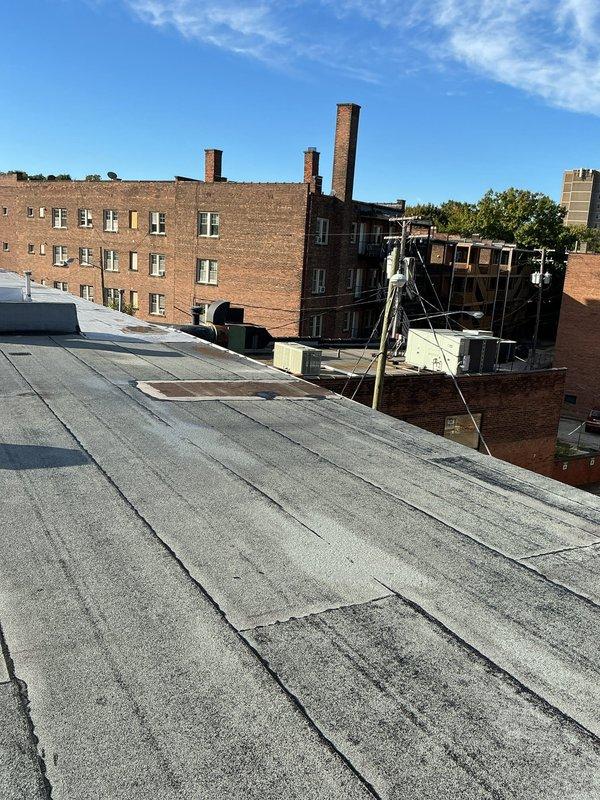 Conducted site assessment for HVAC replacement on commercial rooftop installation. Documented existing ductwork system showing aged metal supply duct with visible wear, weathered ceiling surfaces with water damage indicators, and supporting infrastructure requiring evaluation. Captured equipment positioning and structural conditions to develop comprehensive replacement estimate for system upgrade.