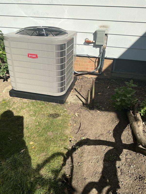 Completed full HVAC system replacement including furnace, evaporator coil, air conditioning condenser unit, Ecobee thermostat, and 700M humidifier. Removed existing equipment and installed new furnace in basement mechanical room with proper venting through white PVC piping routed vertically and horizontally along ceiling joists. Mounted new outdoor condensing unit on composite pad against exterior wall with electrical disconnect box and proper conduit connections. Installed evaporator coil, configured ductwork connections, and integrated humidifier into system. Programmed Ecobee smart thermostat for optimal system operation and verified all components functioning correctly with proper airflow and refrigerant charge.
