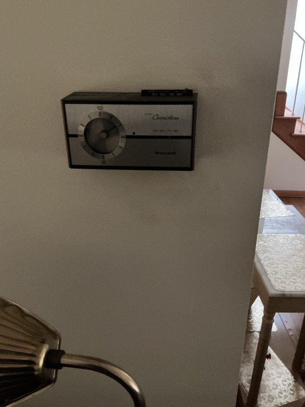 Performed heating system maintenance on an Amana furnace unit (Model 911090290A, Serial 32071884-32) located in the basement. Inspected and verified proper operation of the heating system, confirmed thermostat functionality with Honeywell Chronotherm unit set in the 70-80 degree range, and documented equipment specifications including 115V electrical requirements and 45°F-75°F temperature rise parameters. All components found operating within manufacturer specifications at time of inspection.