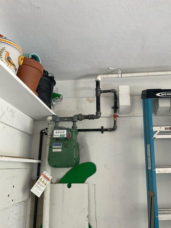 Completed pressure testing and final installation of gas line previously run to garage heater. Initial installation had been performed, but heater manufacturer required pressure testing before commissioning. Gas utility company attempted repair but determined scope exceeded their capabilities. Verified all connections, performed pressure test on gas piping system to manufacturer specifications, confirmed system integrity and proper operation of gas meter and supply lines. All piping secured and tested to code requirements for safe heater operation.