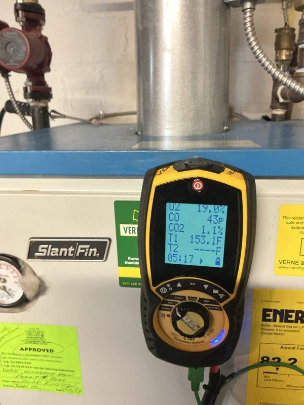 Performed fall tune-up on 6-8 year old Slant/Fin boiler system located in basement. Conducted comprehensive inspection of heat exchanger sections, which showed normal age-related dust accumulation and minor surface oxidation but remained structurally sound with no signs of cracking or failure. Completed combustion analysis using digital analyzer, recording oxygen levels at 19.8%, carbon monoxide at 4.3 ppm, carbon dioxide at 1.1%, and stack temperature at 153.1°F, all within acceptable operating parameters. Verified proper operation of all system controls, pressure gauges, and safety devices. Inspected burner assembly and confirmed clean combustion with no evidence of sooting or incomplete burning. Checked all piping connections, valves, and flexible conduit for secure fittings and proper installation. System currently in off-season mode with no operational issues detected; unit is ready for heating season activation.