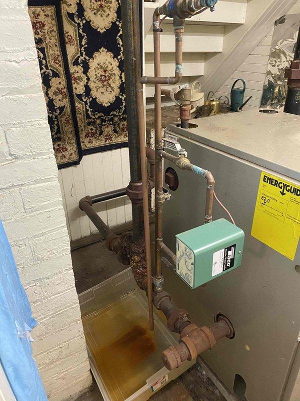 Responded to service call for 20-year-old natural gas steam boiler with active leaking from return piping. Upon inspection, found significant corrosion and deterioration on copper return lines and connections, with visible rust, oxidation, and moisture damage throughout the piping system. Documented extensive wear on steam distribution piping, radiator connections, and associated components showing age-related degradation. Photographed leak source areas and overall system condition for customer records and repair recommendations.