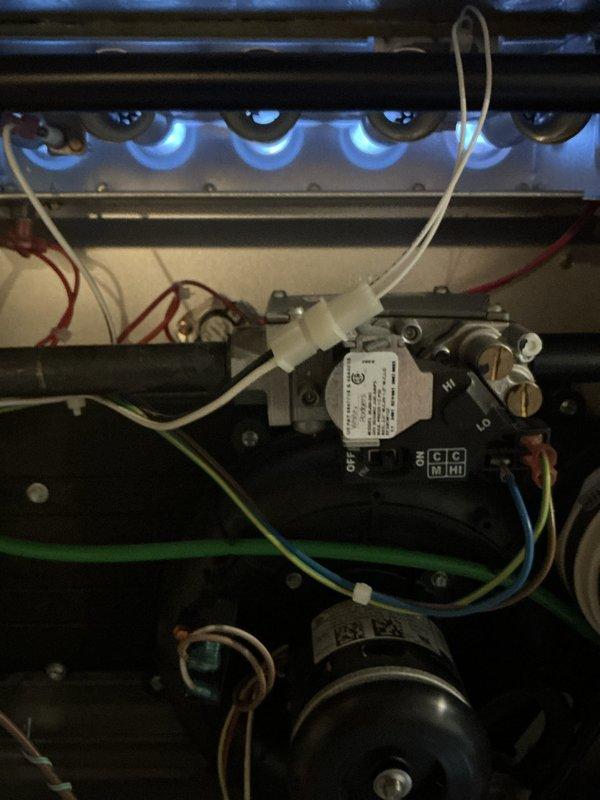 Completed annual maintenance on 2-year-old furnace system. Inspected burner assembly with all flames burning blue and even, indicating proper combustion and gas pressure. Verified all electrical connections to gas valve control assembly, checked wiring integrity, and confirmed blower motor operation within normal parameters.