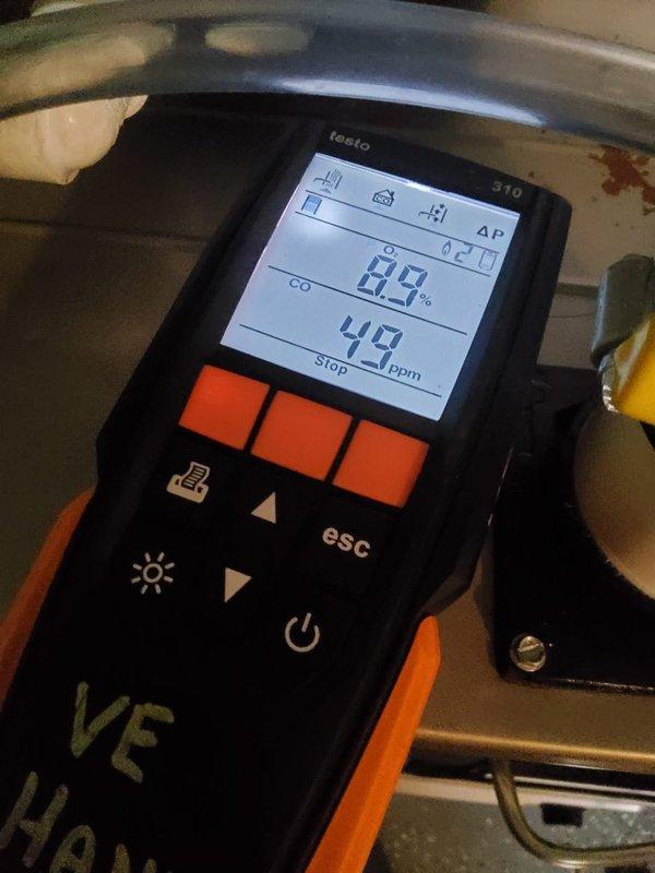 Performed a heating system maintenance inspection on a gas furnace, verifying burner ignition with a clean, stable blue flame and inspecting the gas valve, manifold, and wiring for damage, with no visible rust, frost, or breakage. Conducted combustion analysis with a Testo 310, recording O₂ at 8.9% and CO at 49 ppm, and the system remains operational with combustion readings documented for ongoing monitoring.