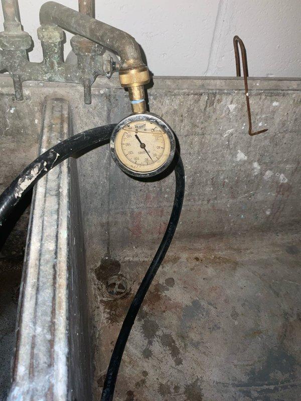 Responded to a no-heat call on a gas-fired storage water heater with a pilot that would not stay lit. Inspected the unit, gas control valve, and burner compartment, and verified the supply piping and flue connections were intact with no signs of leaks or rust. Checked system water pressure at the utility sink gauge to confirm the water supply was within normal operating range.