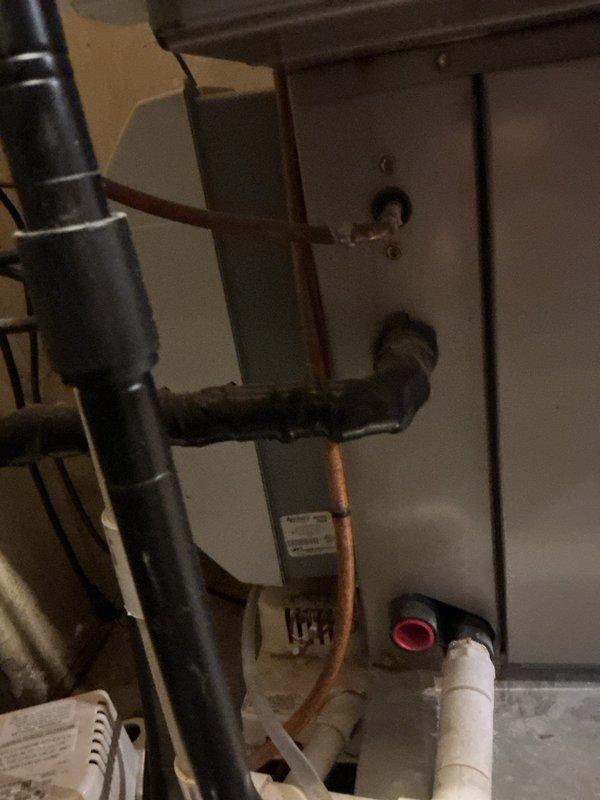 Responded to a no-heat call and inspected the gas furnace/air handler installation, including the refrigerant line set, condensate drain piping with condensate pump, and surrounding utility space. Evaluated the unit's condition and provided a furnace replacement estimate.