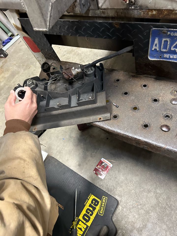 Steven and I repairing brake light with new socket and bulb. 
