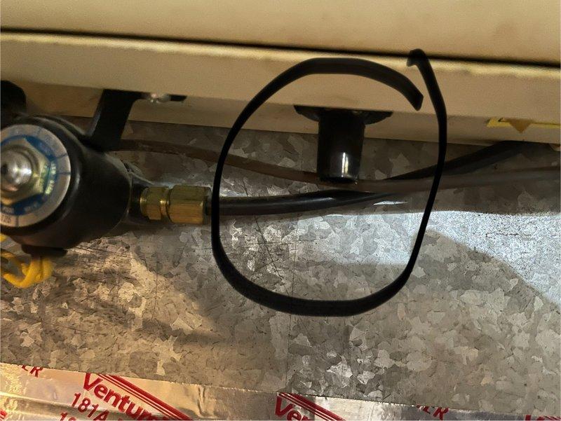 Responded to service call for humidifier leak issue. Inspection revealed the humidifier drain hose was not connected during previous furnace installation. Technician reconnected the drain hose to the Aprilaire humidifier unit, resolving the water leakage problem.