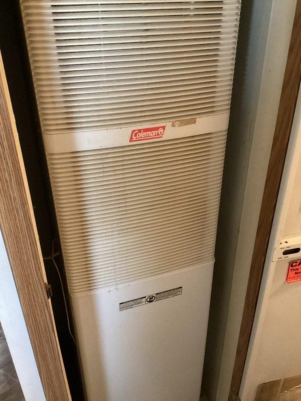 Responded to no heat complaint for residential Coleman furnace. Diagnostic inspection revealed failed heat exchanger on the aging unit (10+ years). Advised customer of two options: replacement of heat exchanger component or complete system replacement. Documented condition with photographs of unit exterior and interior electrical components.