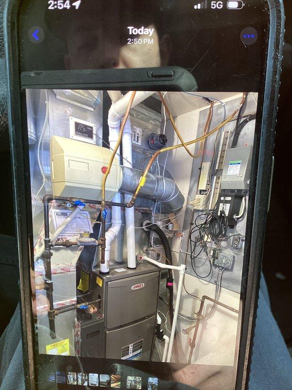 Responded to service call for exhaust pipe freezing issue. Identified condensate from furnace exhaust freezing on home exterior due to vent termination positioned too close to siding. Unable to relocate vent due to structural framing constraints; will require follow-up from Todd to address the situation properly.