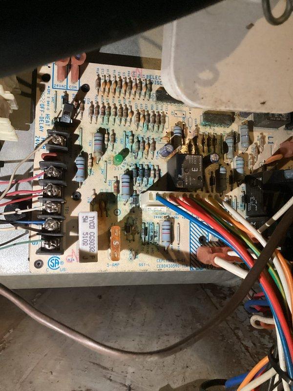 Diagnosed a no-heat issue on an aging furnace system. Inspection revealed the furnace was circulating cool air due to a failed control board, as evidenced by examination of the circuit board components. Recommended replacement options for both the control board and complete system based on unit age exceeding 10 years.