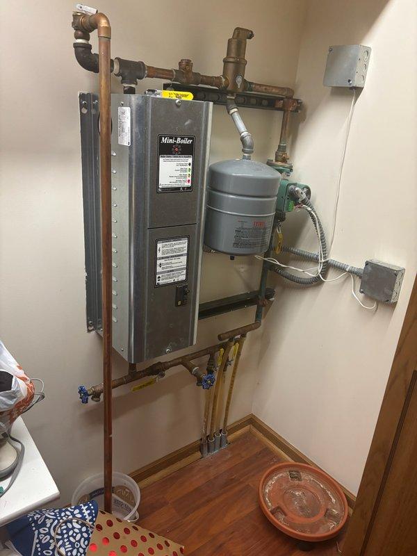 Responded to service call for non-functioning in-floor heating system. Diagnosed Taco 007-ZF5-9 circulation pump connected to mini-boiler operating at 0 PSI. Restored system functionality by filling boiler to proper pressure and cycling the unit to purge air from the system.