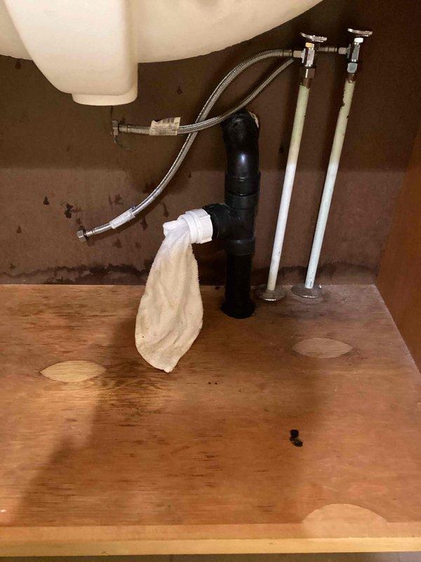 Removed plumbing connections and faucet assembly from hallway bathroom sink in preparation for new vanity installation. Disconnected supply lines and drain assembly, capping off plumbing as required. Will return for reinstallation of faucet and drain components when new vanity is in place.