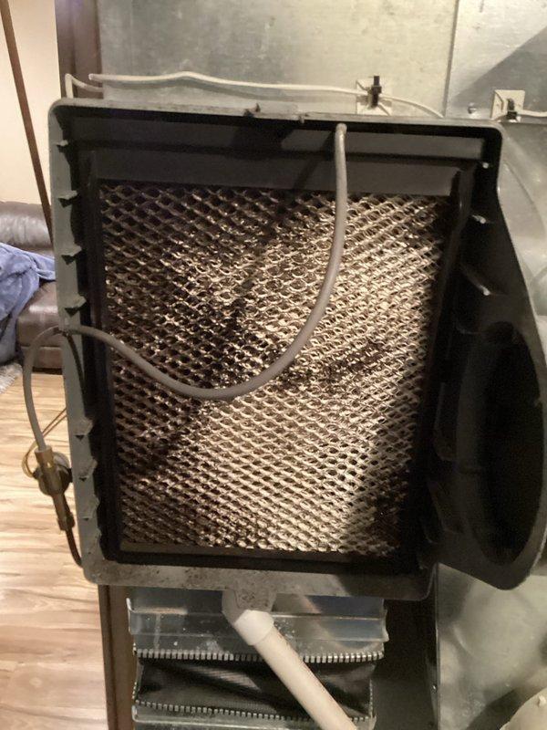 Performed scheduled preventative maintenance agreement service on furnace system. Inspected humidifier unit, noting mineral deposit buildup on evaporative pad requiring attention. Examined air filter assembly which showed visible dust accumulation in filter medium, indicating normal usage patterns.