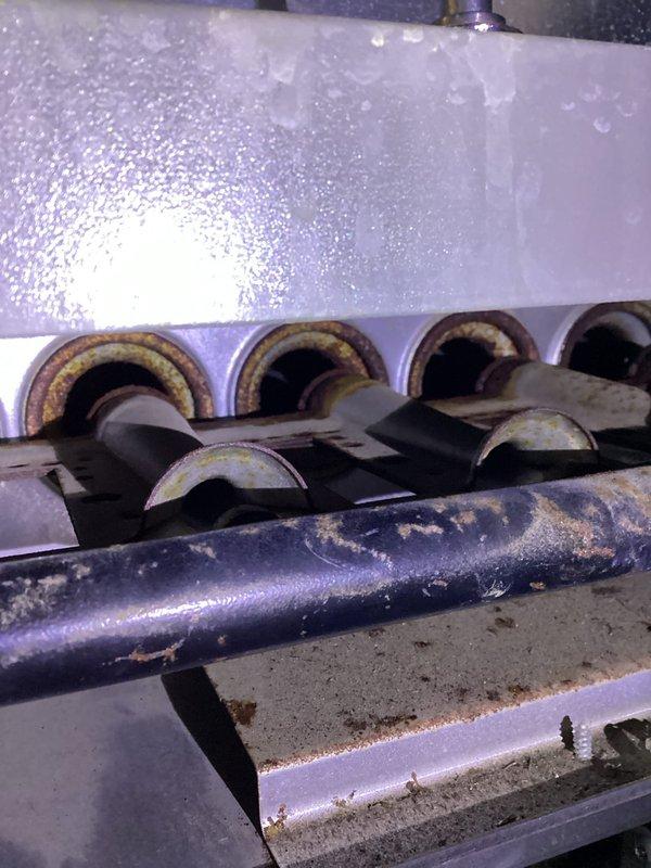Performed scheduled preventive maintenance agreement service on residential furnace. Inspection revealed significant corrosion and rust buildup on heat exchanger components and burner assembly. Exterior condensate drainage system was also examined, with particular attention to the foundation drainage configuration.