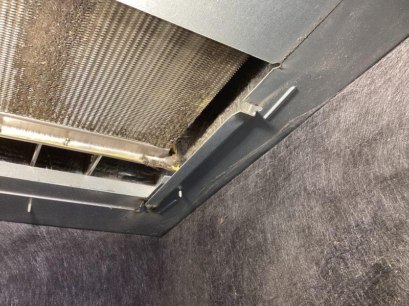 Performed thorough cleaning of the blower motor assembly which had accumulated significant dust and debris on the blower wheel. Also cleaned secondary heat exchanger which showed substantial buildup. Inspected and documented condition of ventilation components, noting dust accumulation on air vents and heat exchanger fins that could impact system efficiency.