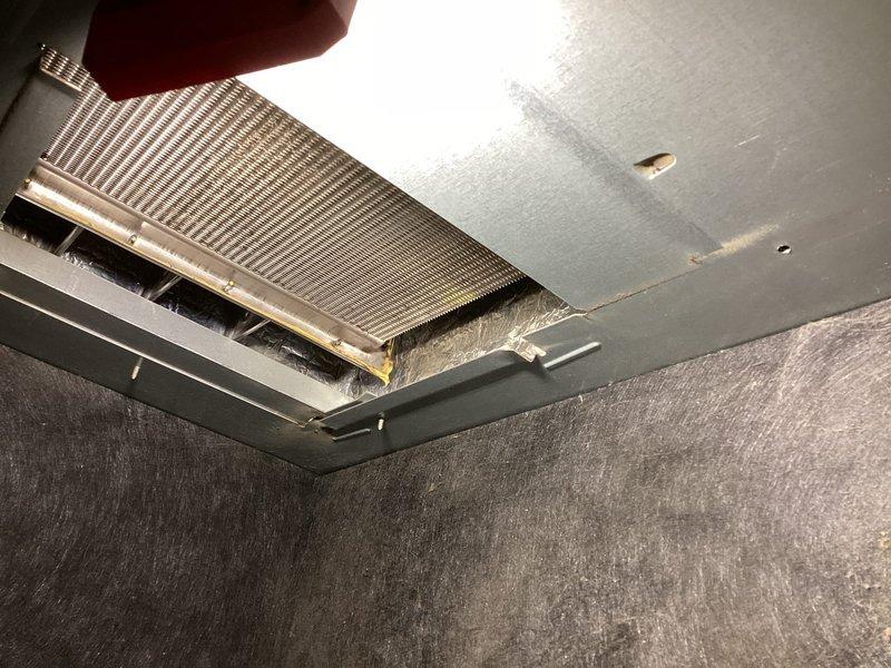 Performed thorough cleaning of the blower motor assembly which had accumulated significant dust and debris on the blower wheel. Also cleaned secondary heat exchanger which showed substantial buildup. Inspected and documented condition of ventilation components, noting dust accumulation on air vents and heat exchanger fins that could impact system efficiency.