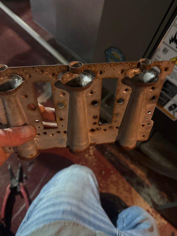 Arrived on site for scheduled installation of new burner assembly and thermostat in aging HVAC system. Removed existing corroded burner assembly which showed significant oxidation on burner tubes and perforated base plate. Successfully completed installation of replacement burner assembly and new thermostat as specified. System functioning properly after service.