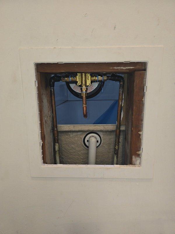 Responded to service call for a shower valve leak. Diagnosed bad solder joint on 1/2" copper 90 fitting at hot water inlet of shower valve. Removed compromised fittings and pipe, then installed new components. Tested system after repair with water turned on, confirming successful resolution of the leak with proper function restored.