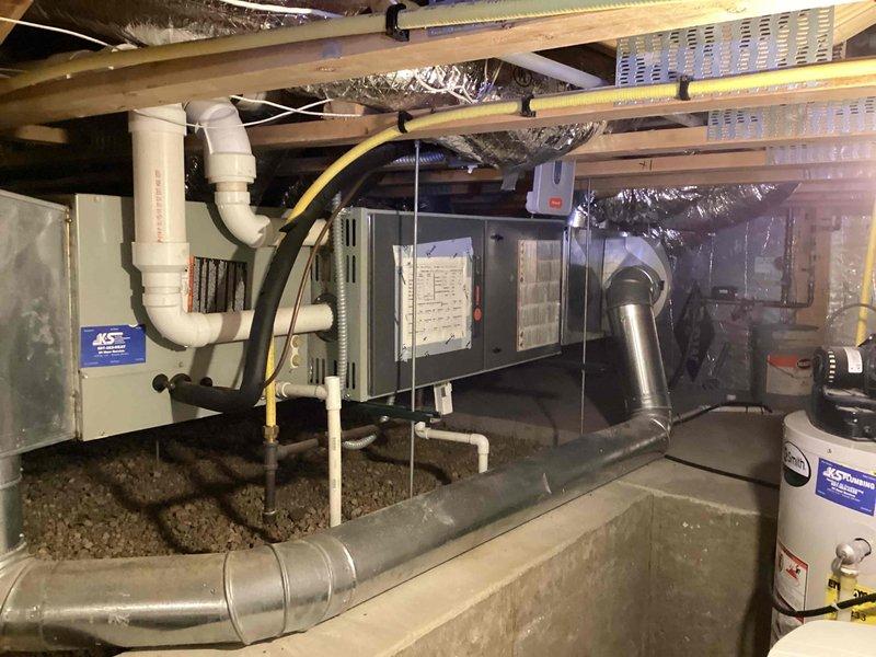 Performed scheduled preventive maintenance agreement (PMA) service on horizontal furnace installed in crawlspace. Inspected complete system including ductwork connections, PVC condensate drainage components, and verified proper mounting of unit between floor joists. System appears to be functioning as designed with no immediate concerns identified.