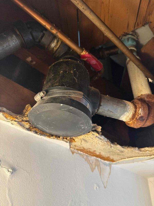Responded to service call for tub leak. Diagnosed issue as a leaking drum trap with visible corrosion and water damage to surrounding materials. Determined replacement of drum trap and overflow assembly necessary; scheduled follow-up appointment with additional technician pending customer financing approval.