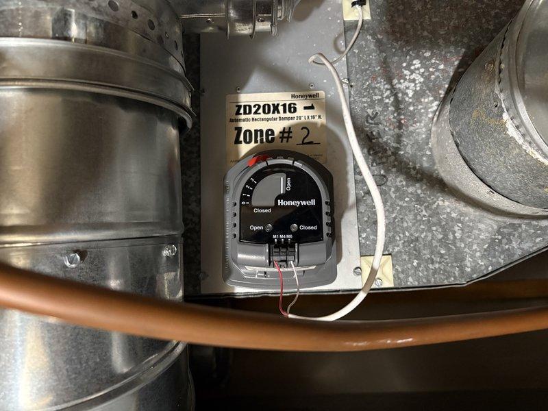Responded to customer complaint regarding Honeywell ZD20X16 automatic damper malfunction in Zone #2. Upon inspection, determined set screw was rubbing against ductwork, causing improper operation. Successfully adjusted damper motor to restore proper functionality of the zoned heating system.