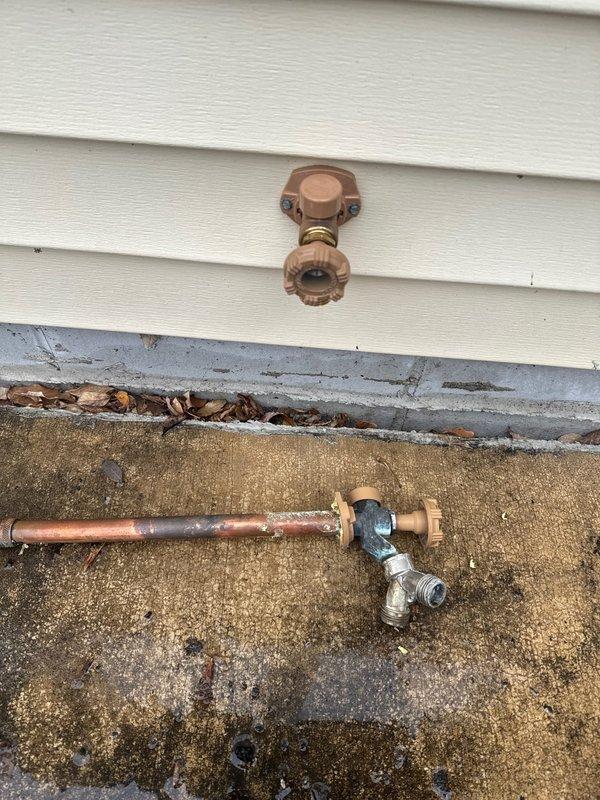 Responded to service call for leaking exterior water spigot (Woodford model 17) located at rear of property. Diagnostic inspection revealed cracked female threads causing water to drip from hose bib. Successfully replaced damaged hose bib, resolving the leak.