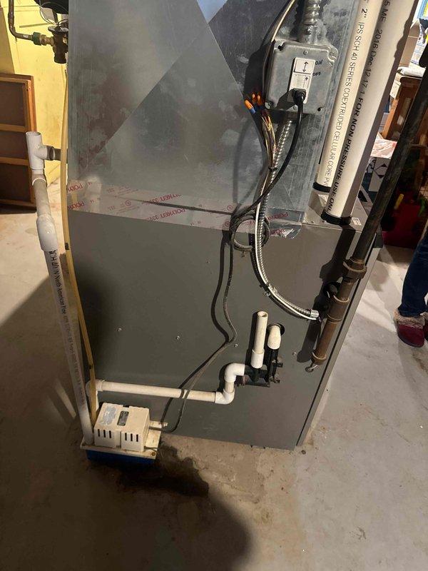 Responded to customer-reported humidifier leak affecting basement floor. Upon inspection, determined GFCI protecting condensate pump had tripped, causing water to overflow. Reset GFCI breaker, monitored system operation and verified proper drainage resumed with no further leakage issues.