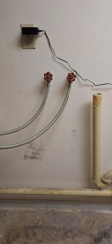 Responded to emergency call regarding leaking cold water faucet connection to washer. Diagnosed issue with laundry hose bibs/boiler drains that were not closing completely. Removed defective boiler drains and installed new valves with green handles. Successfully restored water service with no leaks observed upon system pressurization.