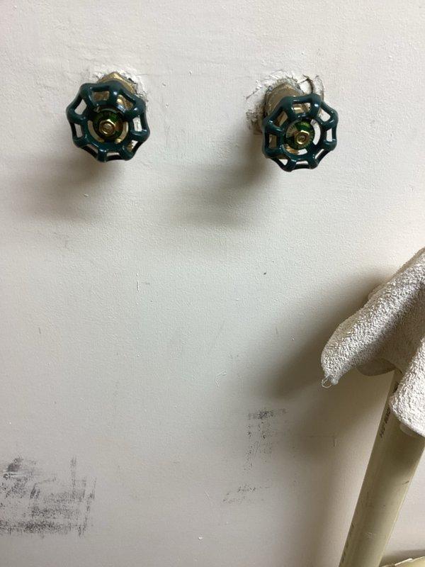 Responded to emergency call regarding leaking cold water faucet connection to washer. Diagnosed issue with laundry hose bibs/boiler drains that were not closing completely. Removed defective boiler drains and installed new valves with green handles. Successfully restored water service with no leaks observed upon system pressurization.