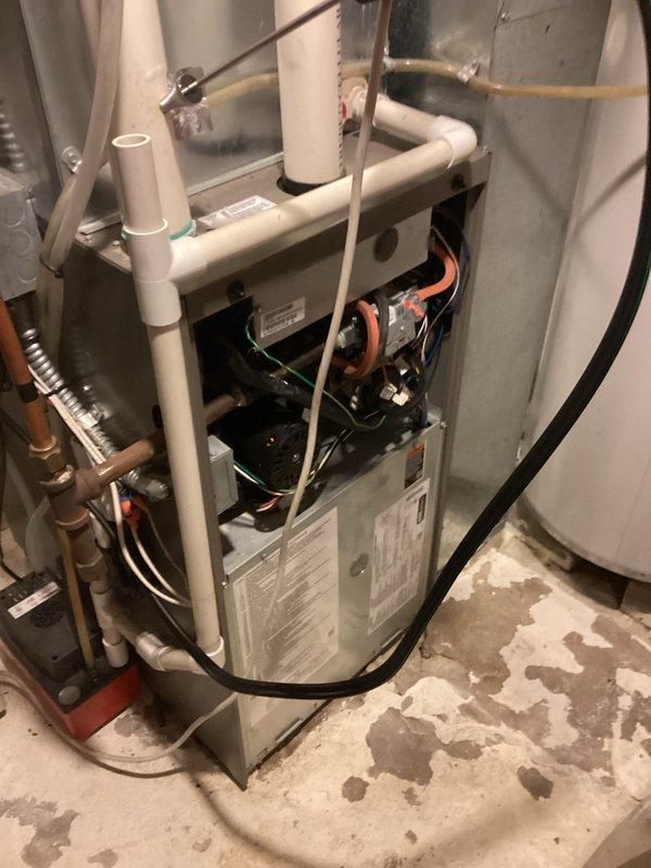 Completed scheduled preventative maintenance agreement service on customer's HVAC system. Inspected furnace components including control board, motor, wiring connections, and drainage system. Noted rust staining on exterior PVC vent pipes requiring future attention.