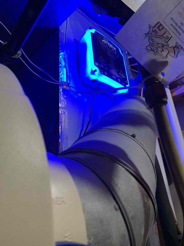 Arrived within scheduled 8-12 window to install filter cabinet upgrade and UV light system. Successfully mounted and connected UV light module to existing HVAC unit, evidenced by the characteristic blue illumination now visible within the system. Completed installation of filter cabinet and verified proper integration with the ductwork and existing mechanical components.