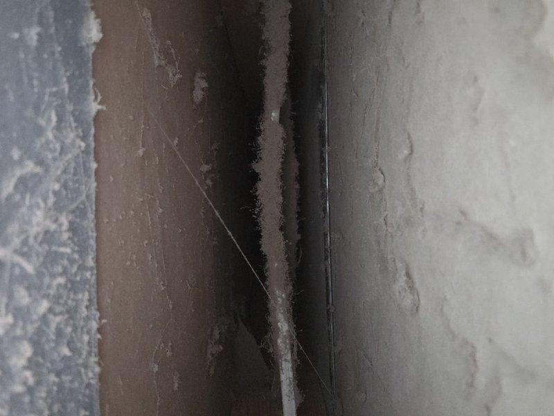 Performed comprehensive duct cleaning service during scheduled 7:30-8am arrival window. Removed significant dust and debris accumulations from the HVAC ductwork system, particularly focusing on corrugated metal ducts showing brownish-orange deposits at joints. Thoroughly cleaned all vents to improve system airflow and indoor air quality.