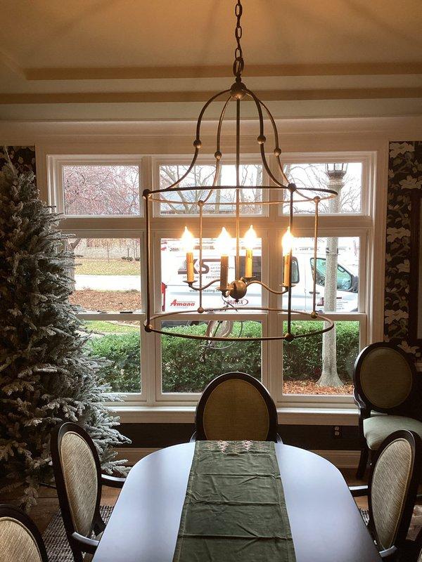 Successfully removed existing chandelier in dining room and installed new cage-style decorative fixture with multiple candle-shaped bulbs. Ensured proper wiring connections and secure mounting of the new light fixture. Confirmed proper operation before completing service.