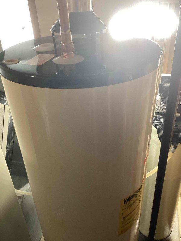 Diagnosed natural gas water heater leaking through tank during fill cycle. Inspection confirmed internal tank failure with water leaking from bottom. Recommended replacement with new 40-gallon atmospheric vent NG water heater, and customer will schedule installation appointment.